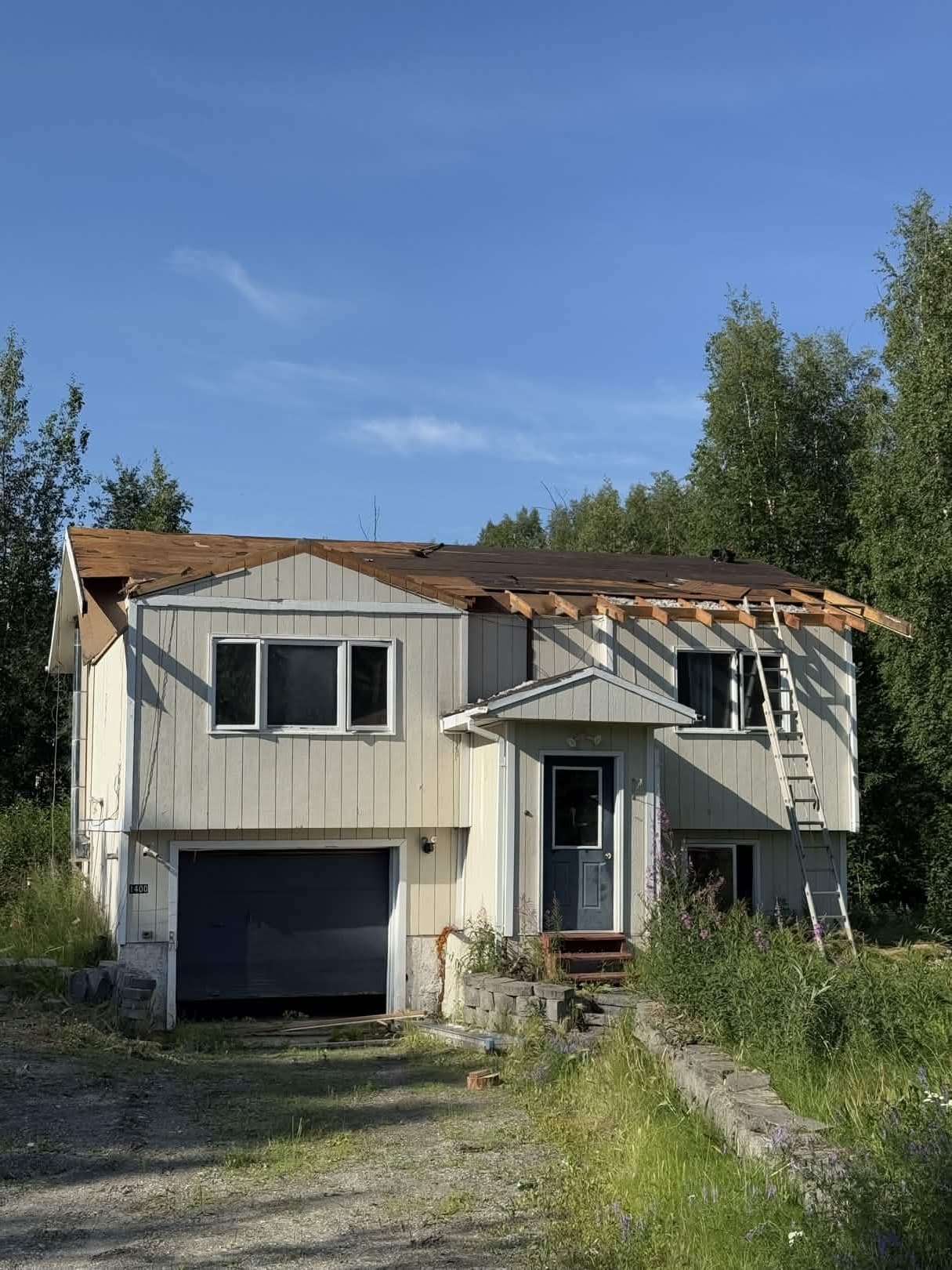 House before renovation — worn exterior with roof damage